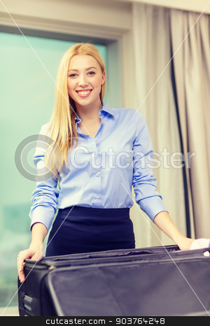 To use this stock image in your creative project, please select the size you need over to the right and click the "Add to Cart" button.
Your downloaded image will come with the Cutcaster watermark removed so don’t worry about the watermark you see on this page. businesswoman packing things in suitcase stock photo, business, technology, internet and hotel concept - happy businesswoman packing things in suitcase in hotel room by Syda Productions