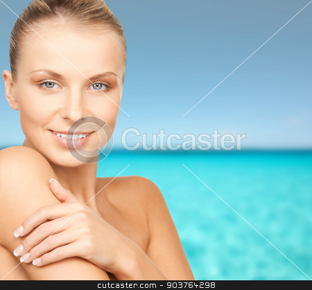 To use this stock image in your creative project, please select the size you need over to the right and click the "Add to Cart" button.
Your downloaded image will come with the Cutcaster watermark removed so don’t worry about the watermark you see on this page. beautiful young woman with bare shoulders stock photo, beauty, people and health concept - beautiful young woman with bare shoulders over blue water and sky background by Syda Productions