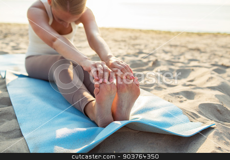 To use this stock image in your creative project, please select the size you need over to the right and click the "Add to Cart" button.
Your downloaded image will come with the Cutcaster watermark removed so don’t worry about the watermark you see on this page. close up of woman making yoga exercises outdoors stock photo, fitness, sport, people and lifestyle concept - close up of woman making yoga exercises on mat outdoors by Syda Productions