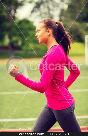To use this stock image in your creative project, please select the size you need over to the right and click the "Add to Cart" button.
Your downloaded image will come with the Cutcaster watermark removed so don’t worry about the watermark you see on this page. smiling woman running on track outdoors stock photo, fitness, sport, training and lifestyle concept - smiling african american woman running on track outdoors by Syda Productions