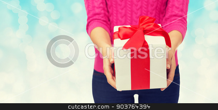 To use this stock image in your creative project, please select the size you need over to the right and click the "Add to Cart" button.
Your downloaded image will come with the Cutcaster watermark removed so don’t worry about the watermark you see on this page. close up of woman in pink sweater holding gift box stock photo, christmas, holidays and people concept - close up of woman in pink sweater holding gift box over blue lights background by Syda Productions