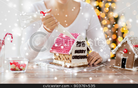 To use this stock image in your creative project, please select the size you need over to the right and click the "Add to Cart" button.
Your downloaded image will come with the Cutcaster watermark removed so don’t worry about the watermark you see on this page. close up of woman making gingerbread houses stock photo, cooking, people, christmas and decoration concept - happy woman making gingerbread houses at home by Syda Productions