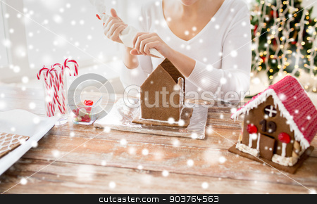 To use this stock image in your creative project, please select the size you need over to the right and click the "Add to Cart" button.
Your downloaded image will come with the Cutcaster watermark removed so don’t worry about the watermark you see on this page. close up of woman making gingerbread houses stock photo, cooking, people, christmas and decoration concept - happy woman making gingerbread houses at home by Syda Productions