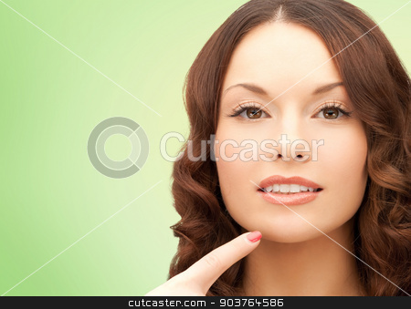 To use this stock image in your creative project, please select the size you need over to the right and click the "Add to Cart" button.
Your downloaded image will come with the Cutcaster watermark removed so don’t worry about the watermark you see on this page. beautiful young woman pointing finger to her chin stock photo, beauty, people and health concept - beautiful young woman pointing finger to her chin over green background by Syda Productions