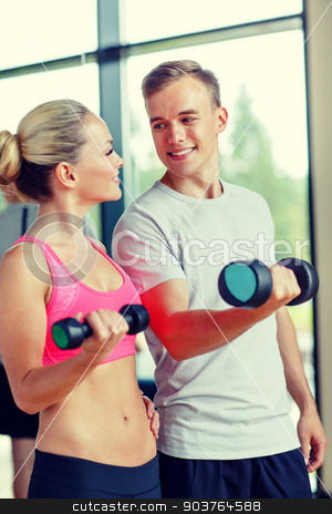 To use this stock image in your creative project, please select the size you need over to the right and click the "Add to Cart" button.
Your downloaded image will come with the Cutcaster watermark removed so don’t worry about the watermark you see on this page. smiling young woman with personal trainer in gym stock photo, fitness, sport, exercising and diet concept - smiling young woman and personal trainer with dumbbells in gym by Syda Productions