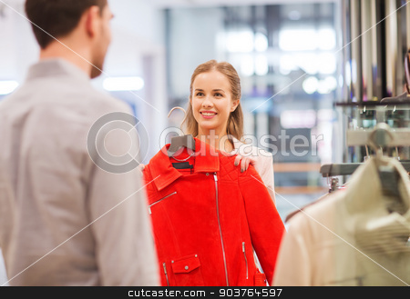 To use this stock image in your creative project, please select the size you need over to the right and click the "Add to Cart" button.
Your downloaded image will come with the Cutcaster watermark removed so don’t worry about the watermark you see on this page. happy young couple choosing clothes in mall stock photo, sale, shopping, consumerism and people concept - happy young couple choosing clothes at clothing store in mall by Syda Productions