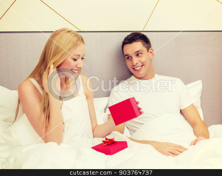 To use this stock image in your creative project, please select the size you need over to the right and click the "Add to Cart" button.
Your downloaded image will come with the Cutcaster watermark removed so don’t worry about the watermark you see on this page. man giving woman little red gift box stock photo, hotel, travel, relationships, holidays and happiness concept - man giving woman little red gift box by Syda Productions