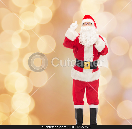 To use this stock image in your creative project, please select the size you need over to the right and click the "Add to Cart" button.
Your downloaded image will come with the Cutcaster watermark removed so don’t worry about the watermark you see on this page. man in costume of santa claus with bag stock photo, christmas, holidays, gesture and people concept - man in costume of santa claus with bag pointing finger up over beige lights background by Syda Productions