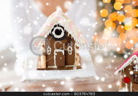 To use this stock image in your creative project, please select the size you need over to the right and click the "Add to Cart" button.
Your downloaded image will come with the Cutcaster watermark removed so don’t worry about the watermark you see on this page. close up of woman showing gingerbread house stock photo, cooking, people, christmas and baking concept - close up of happy woman holding and showing gingerbread house at home by Syda Productions