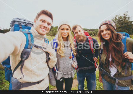 To use this stock image in your creative project, please select the size you need over to the right and click the "Add to Cart" button.
Your downloaded image will come with the Cutcaster watermark removed so don’t worry about the watermark you see on this page. group of smiling friends with backpacks hiking stock photo, adventure, travel, tourism, hike and people concept - group of smiling friends with backpacks making selfie outdoors by Syda Productions