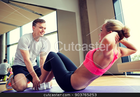 To use this stock image in your creative project, please select the size you need over to the right and click the "Add to Cart" button.
Your downloaded image will come with the Cutcaster watermark removed so don’t worry about the watermark you see on this page. woman with personal trainer doing sit ups in gym stock photo, fitness, sport, training, gym and lifestyle concept - woman with personal trainer doing sit ups in gym by Syda Productions