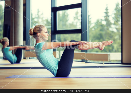 To use this stock image in your creative project, please select the size you need over to the right and click the "Add to Cart" button.
Your downloaded image will come with the Cutcaster watermark removed so don’t worry about the watermark you see on this page. smiling woman doing exercises on mat in gym stock photo, fitness, sport, training and people concept - smiling woman doing abdominal exercises on mat in gym by Syda Productions