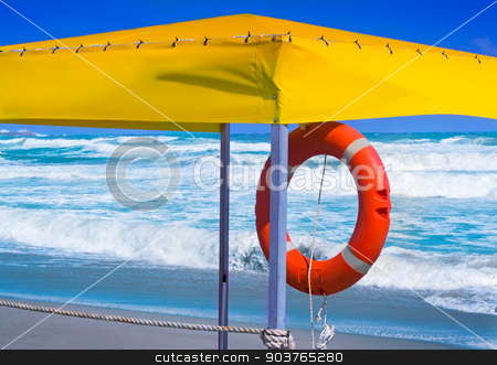 To use this stock image in your creative project, please select the size you need over to the right and click the "Add to Cart" button.
Your downloaded image will come with the Cutcaster watermark removed so don’t worry about the watermark you see on this page. A lifeline to rescue drowning in the sea. stock photo, On the shore of a stormy sea under the awning hanging red lifeline to rescue the drowning. by Georgina198