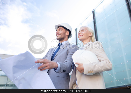 To use this stock image in your creative project, please select the size you need over to the right and click the "Add to Cart" button.
Your downloaded image will come with the Cutcaster watermark removed so don’t worry about the watermark you see on this page. smiling businessmen with blueprint and helmets stock photo, business, partnership, architecture and people concept - smiling businessman and businesswoman with blueprint and helmets on city street by Syda Productions