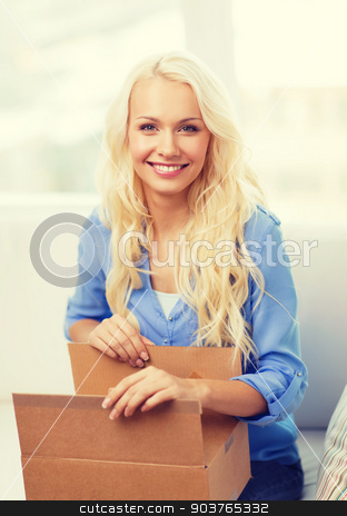 To use this stock image in your creative project, please select the size you need over to the right and click the "Add to Cart" button.
Your downloaded image will come with the Cutcaster watermark removed so don’t worry about the watermark you see on this page. smiling young woman opening cardboard box at home stock photo, home, post, delivery and happiness concept - smiling young woman opening cardboard box at home by Syda Productions