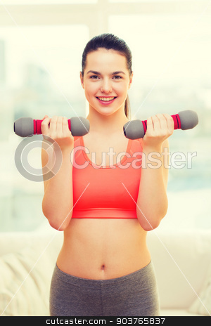 To use this stock image in your creative project, please select the size you need over to the right and click the "Add to Cart" button.
Your downloaded image will come with the Cutcaster watermark removed so don’t worry about the watermark you see on this page. smiling teenage girl exercising with dumbbells stock photo, fitness, home and diet concept - smiling redhead girl exercising with heavy dumbbells at home by Syda Productions