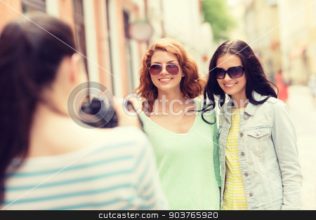 To use this stock image in your creative project, please select the size you need over to the right and click the "Add to Cart" button.
Your downloaded image will come with the Cutcaster watermark removed so don’t worry about the watermark you see on this page. smiling teenage girls with camera stock photo, tourism, travel, leisure, holidays and friendship concept - smiling teenage girls with camera outdoors by Syda Productions