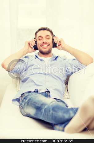 To use this stock image in your creative project, please select the size you need over to the right and click the "Add to Cart" button.
Your downloaded image will come with the Cutcaster watermark removed so don’t worry about the watermark you see on this page. smiling young man in headphones at home stock photo, technology, music and happiness concept - smiling young man in headphones at home by Syda Productions