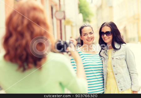 To use this stock image in your creative project, please select the size you need over to the right and click the "Add to Cart" button.
Your downloaded image will come with the Cutcaster watermark removed so don’t worry about the watermark you see on this page. smiling teenage girls with camera stock photo, tourism, travel, leisure, holidays and friendship concept - smiling teenage girls with camera outdoors by Syda Productions