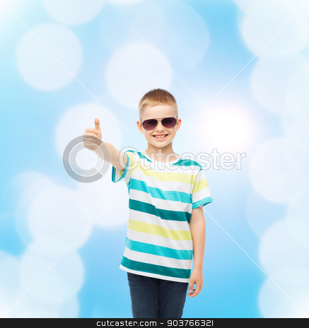 To use this stock image in your creative project, please select the size you need over to the right and click the "Add to Cart" button.
Your downloaded image will come with the Cutcaster watermark removed so don’t worry about the watermark you see on this page. smiling cute little boy in sunglasses stock photo, happiness, summer, childhood, gesture and people concept - smiling cute little boy in sunglasses over blue background showing thumbs up by Syda Productions