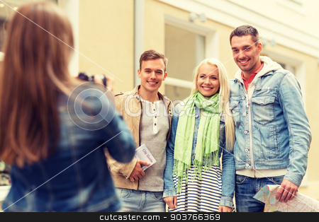 To use this stock image in your creative project, please select the size you need over to the right and click the "Add to Cart" button.
Your downloaded image will come with the Cutcaster watermark removed so don’t worry about the watermark you see on this page. group of smiling friends taking photo outdoors stock photo, travel, vacation, technology and friendship concept - girl picturing group of friends with map and city guide in city by Syda Productions