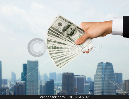 To use this stock image in your creative project, please select the size you need over to the right and click the "Add to Cart" button.
Your downloaded image will come with the Cutcaster watermark removed so don’t worry about the watermark you see on this page. close up of male hand holding dollar cash money stock photo, finances, people, savings and investment concept - close up of male hand holding dollar cash money over city background by Syda Productions
