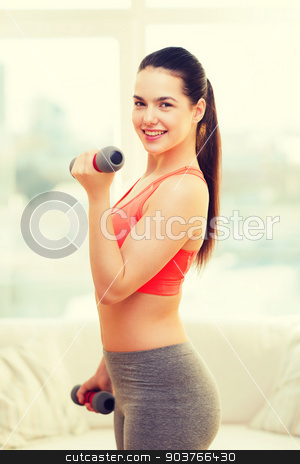 To use this stock image in your creative project, please select the size you need over to the right and click the "Add to Cart" button.
Your downloaded image will come with the Cutcaster watermark removed so don’t worry about the watermark you see on this page. smiling teenage girl exercising with dumbbells stock photo, fitness, home and diet concept - smiling redhead girl exercising with heavy dumbbells at home by Syda Productions