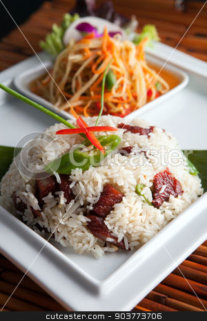 To use this stock image in your creative project, please select the size you need over to the right and click the "Add to Cart" button.
Your downloaded image will come with the Cutcaster watermark removed so don’t worry about the watermark you see on this page. Thai Pork Ribs and Rice Dish stock photo, Traditional dish of freshly prepared Thai food with som tum green papaya salad. by Todd Arena