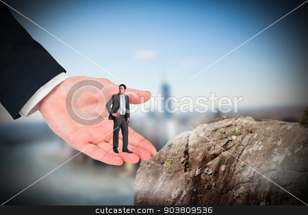 To use this stock image in your creative project, please select the size you need over to the right and click the "Add to Cart" button.
Your downloaded image will come with the Cutcaster watermark removed so don’t worry about the watermark you see on this page. Composite image of serious businessman with hand on hip in large stock photo, Serious businessman with hand on hip in large hand against large rock overlooking foggy city by Wavebreak Media