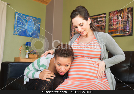 To use this stock image in your creative project, please select the size you need over to the right and click the "Add to Cart" button.
Your downloaded image will come with the Cutcaster watermark removed so don’t worry about the watermark you see on this page. Listening to Womb of Partner stock photo, Lesbian spouse of pregnant woman listening to her womb by Scott Griessel