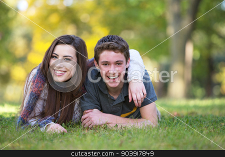 To use this stock image in your creative project, please select the size you need over to the right and click the "Add to Cart" button.
Your downloaded image will come with the Cutcaster watermark removed so don’t worry about the watermark you see on this page. Smiling Boyfriend and Girlfriend stock photo, Smiling male and female teen friends relaxing outdoors by Scott Griessel
