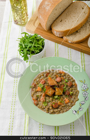 To use this stock image in your creative project, please select the size you need over to the right and click the "Add to Cart" button.
Your downloaded image will come with the Cutcaster watermark removed so don’t worry about the watermark you see on this page. Lentil soup with Viennese sausage stock photo, Lentil soup with Viennese sausage and croutons by Peteer