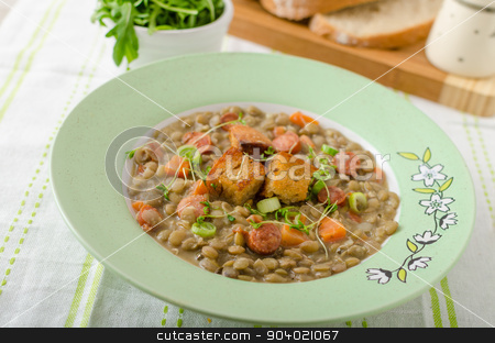 To use this stock image in your creative project, please select the size you need over to the right and click the "Add to Cart" button.
Your downloaded image will come with the Cutcaster watermark removed so don’t worry about the watermark you see on this page. Lentil soup with Viennese sausage stock photo, Lentil soup with Viennese sausage and croutons by Peteer