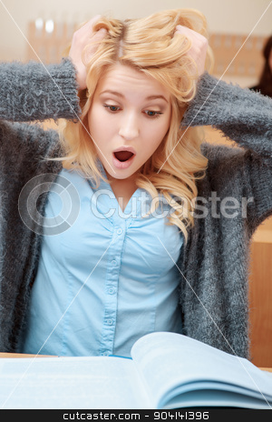 To use this stock image in your creative project, please select the size you need over to the right and click the "Add to Cart" button.
Your downloaded image will come with the Cutcaster watermark removed so don’t worry about the watermark you see on this page. Female student surprised at class stock photo, Oh my God. Young beautiful blond female student grabs her head looking with surprise and astonishment into the exercise book by Zinkevych