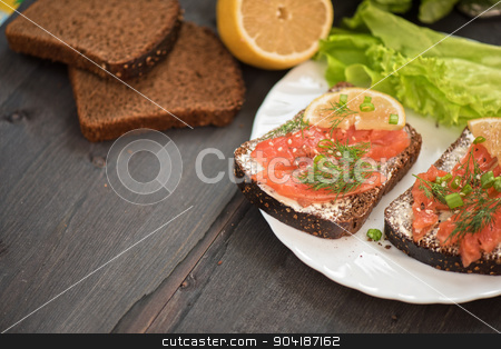 To use this stock image in your creative project, please select the size you need over to the right and click the "Add to Cart" button.
Your downloaded image will come with the Cutcaster watermark removed so don’t worry about the watermark you see on this page. Sandwich with salmon for breakfast stock photo, Homemade sandwich with salmon and rye bread , butter lemon, and lettuce for breakfast by olinchuk
