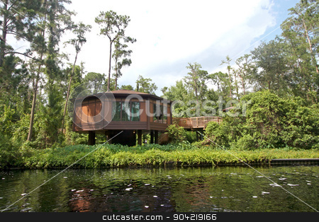 To use this stock image in your creative project, please select the size you need over to the right and click the "Add to Cart" button.
Your downloaded image will come with the Cutcaster watermark removed so don’t worry about the watermark you see on this page. Treehouse stock photo, A treehouse in the forest next to a river by Lucy Clark