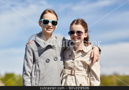 To use this stock image in your creative project, please select the size you need over to the right and click the "Add to Cart" button.
Your downloaded image will come with the Cutcaster watermark removed so don’t worry about the watermark you see on this page. happy little girls in sunglasses hugging outdoors stock photo, people, children, friends and friendship concept - happy little girls in sunglasses hugging outdoors by Syda Productions