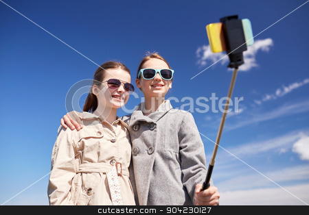 To use this stock image in your creative project, please select the size you need over to the right and click the "Add to Cart" button.
Your downloaded image will come with the Cutcaster watermark removed so don’t worry about the watermark you see on this page. happy girls with smartphone selfie stick stock photo, people, children, friends and friendsip concept - happy girls taking picture with smartphone on selfie stick outdoors by Syda Productions
