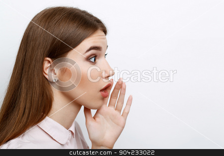 To use this stock image in your creative project, please select the size you need over to the right and click the "Add to Cart" button.
Your downloaded image will come with the Cutcaster watermark removed so don’t worry about the watermark you see on this page. Beautiful girl showing emotions stock photo, Portrait of a young beautiful girl with long brown hair wearing pink cotton blouse, standing in a profile telling someone a secret holding her hand near mouth, on a white background by Zinkevych