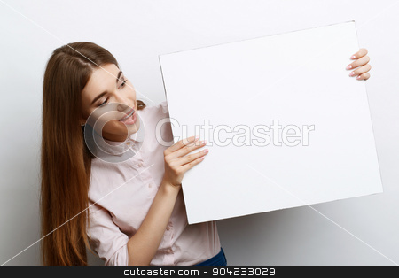 To use this stock image in your creative project, please select the size you need over to the right and click the "Add to Cart" button.
Your downloaded image will come with the Cutcaster watermark removed so don’t worry about the watermark you see on this page. Beautiful girl with copy space stock photo, Portrait of a young beautiful girl with long brown hair wearing pink cotton blouse, standing holding a copy space in her hands and looking excited at it, on a white background by Zinkevych
