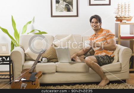 To use this stock image in your creative project, please select the size you need over to the right and click the "Add to Cart" button.
Your downloaded image will come with the Cutcaster watermark removed so don’t worry about the watermark you see on this page. pims_20090401_sh0271.jpg stock photo, Young man holding a coffee mug in the living room by imagedb
