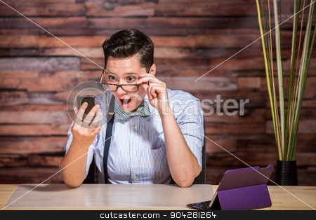 To use this stock image in your creative project, please select the size you need over to the right and click the "Add to Cart" button.
Your downloaded image will come with the Cutcaster watermark removed so don’t worry about the watermark you see on this page. Businesswoman Looking Over Eyeglasses stock photo, Surprised dapper businesswoman looking over eyeglasses at phone by Scott Griessel