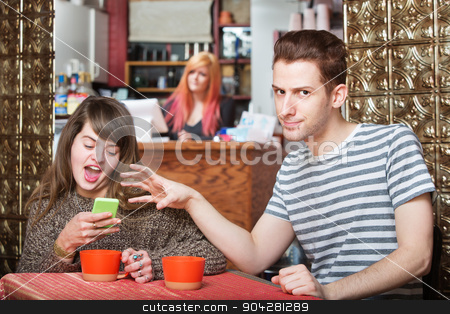To use this stock image in your creative project, please select the size you need over to the right and click the "Add to Cart" button.
Your downloaded image will come with the Cutcaster watermark removed so don’t worry about the watermark you see on this page. Annoyed Man Snatching Back Phone stock photo, Annoyed man in cafe snatching phone from woman by Scott Griessel