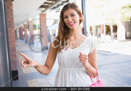 To use this stock image in your creative project, please select the size you need over to the right and click the "Add to Cart" button.
Your downloaded image will come with the Cutcaster watermark removed so don’t worry about the watermark you see on this page. Portrait of smiling woman pointing the window and looking at cam stock photo, Portrait of smiling woman pointing the window and looking at camera at the shopping mall by Wavebreak Media