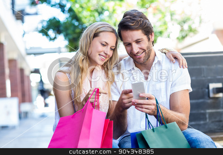 To use this stock image in your creative project, please select the size you need over to the right and click the "Add to Cart" button.
Your downloaded image will come with the Cutcaster watermark removed so don’t worry about the watermark you see on this page. Smiling couple with shopping bags sitting and using smartphone stock photo, Smiling couple with shopping bags sitting and using smartphone at shopping mall by Wavebreak Media