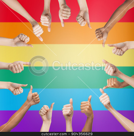 To use this stock image in your creative project, please select the size you need over to the right and click the "Add to Cart" button.
Your downloaded image will come with the Cutcaster watermark removed so don’t worry about the watermark you see on this page. hands showing thumbs up in circle over rainbow stock photo, people, gay pride, gesture and homosexual concept - human hands showing thumbs up in circle over rainbow flag stripes background by Syda Productions