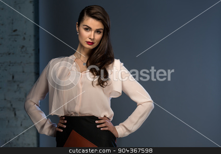To use this stock image in your creative project, please select the size you need over to the right and click the "Add to Cart" button.
Your downloaded image will come with the Cutcaster watermark removed so don’t worry about the watermark you see on this page. Portrait glamorous brown-haired business style girl stock photo, Portrait glamorous brown-haired business style girl dressed in a blouse and a leather skirt by bezikus