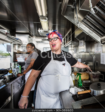 To use this stock image in your creative project, please select the size you need over to the right and click the "Add to Cart" button.
Your downloaded image will come with the Cutcaster watermark removed so don’t worry about the watermark you see on this page. Female Chef on Food Truck stock photo, Chef with pink hair directs staff on food truck by Scott Griessel