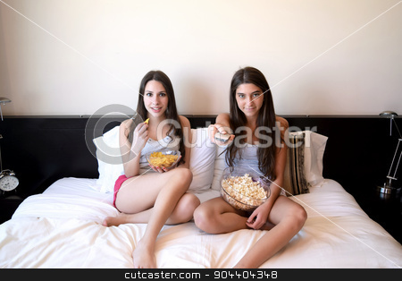 To use this stock image in your creative project, please select the size you need over to the right and click the "Add to Cart" button.
Your downloaded image will come with the Cutcaster watermark removed so don’t worry about the watermark you see on this page. Best friends watching tv or a movie in bed stock photo, Two beautiful young women in bed watching a movie or tv, pointing the remote control to the camera. by nicolas menijes
