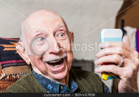 To use this stock image in your creative project, please select the size you need over to the right and click the "Add to Cart" button.
Your downloaded image will come with the Cutcaster watermark removed so don’t worry about the watermark you see on this page. Elderly Gentleman with Smartphone stock photo, Elderly gentleman taking a selfie with smartphone by Scott Griessel